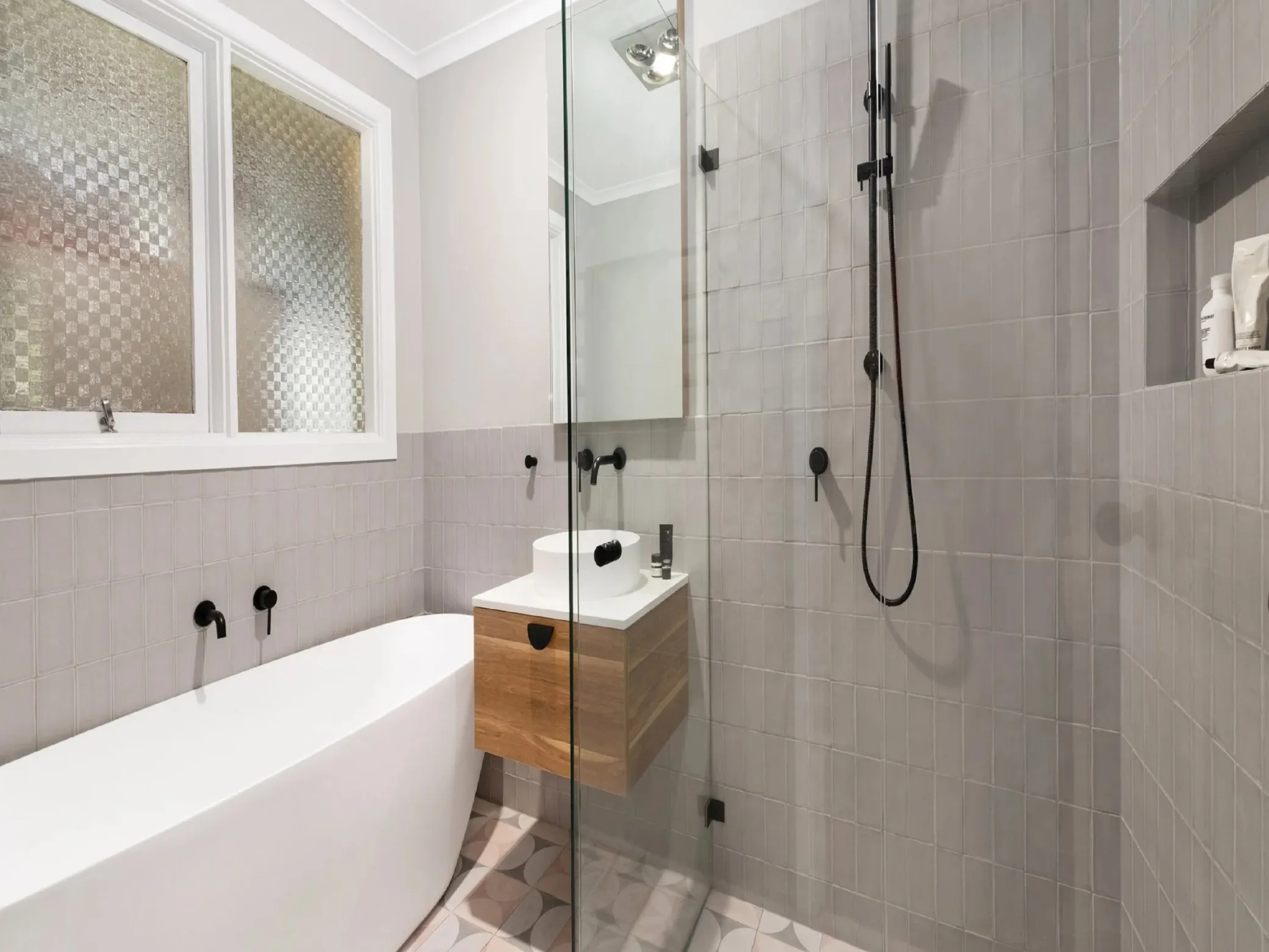Modern bathroom renovation with glass shower and floating vanity Thunder Bay