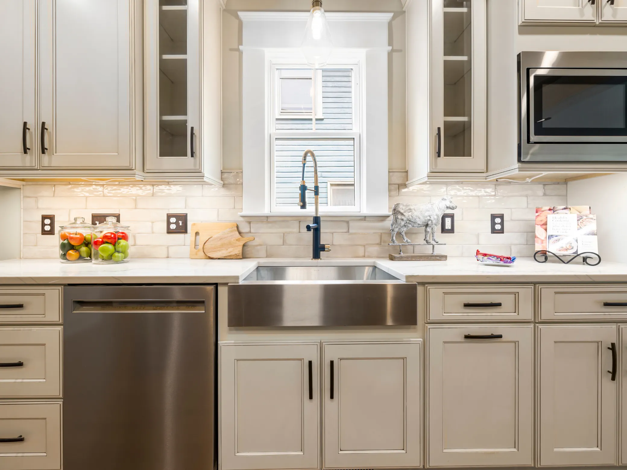 Renovated white kitchen with dark cabinets and marble countertops Thunder Bay